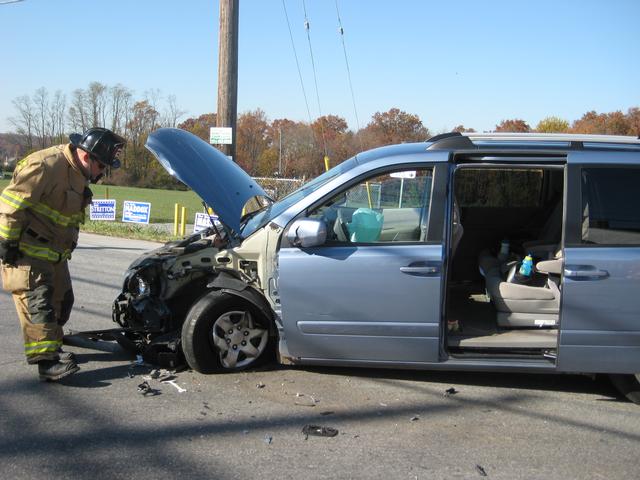 Firefighter BJ Meadowcroft securing a vehicle at a crash in Lincoln.